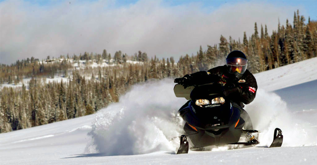 Snowmobiling on a winter trail near Warrensburg, New York