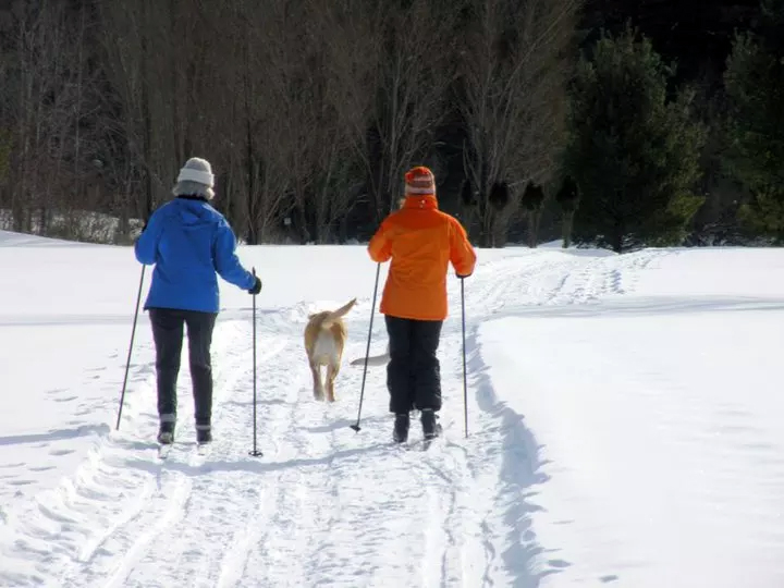 Snowshoeing and cross-country skiing on a winter trail in Warrensburg, New York